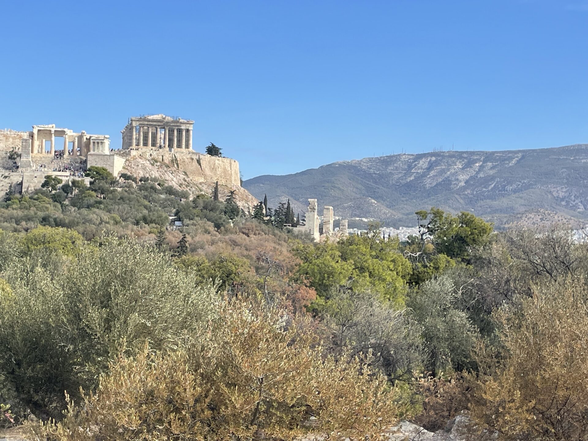 Vue panoramique depuis la colline de Philopappos à Athènes, offrant une vue imprenable sur l'Acropole, la ville d'Athènes et la mer Égée, tout en capturant la beauté historique et naturelle de la capitale grecque.